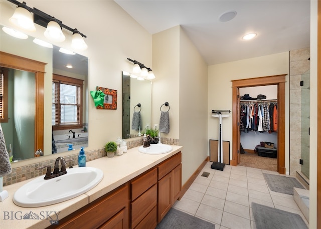 bathroom featuring tile patterned floors, independent shower and bath, and dual vanity