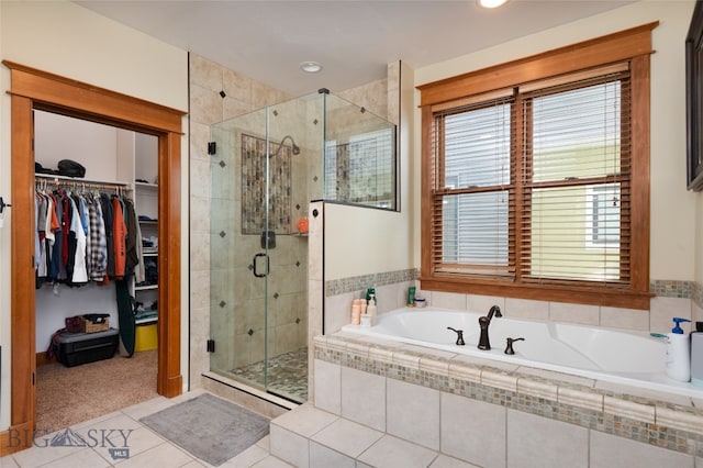 bathroom with tile patterned floors and independent shower and bath