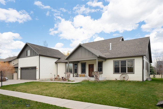 view of front of home with covered porch, a garage, and a front yard