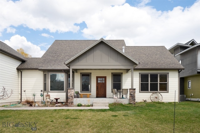 view of front facade with central air condition unit, a front lawn, and covered porch