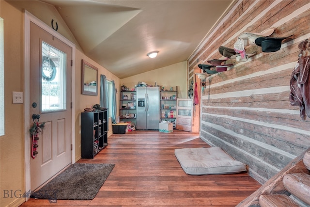 entryway featuring dark wood-type flooring and vaulted ceiling