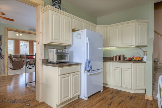 kitchen featuring ceiling fan, white fridge, and dark hardwood / wood-style floors