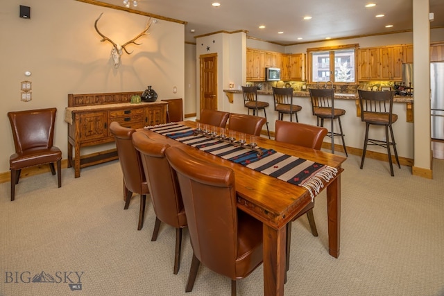 dining area featuring light carpet