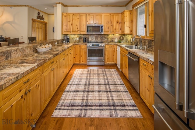 kitchen with stainless steel appliances, tasteful backsplash, dark wood-type flooring, crown molding, and sink