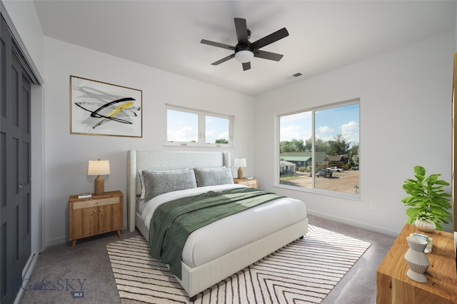 carpeted bedroom featuring a closet and ceiling fan