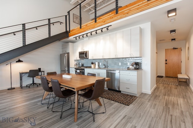 dining room featuring sink and light hardwood / wood-style flooring