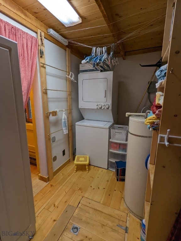 washroom with stacked washer and clothes dryer, light wood-type flooring, and wooden ceiling