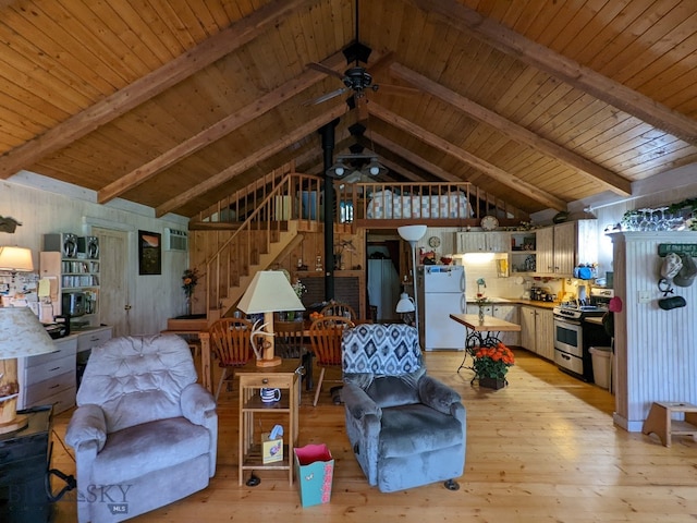 living room with beamed ceiling, wood ceiling, ceiling fan, and light hardwood / wood-style flooring