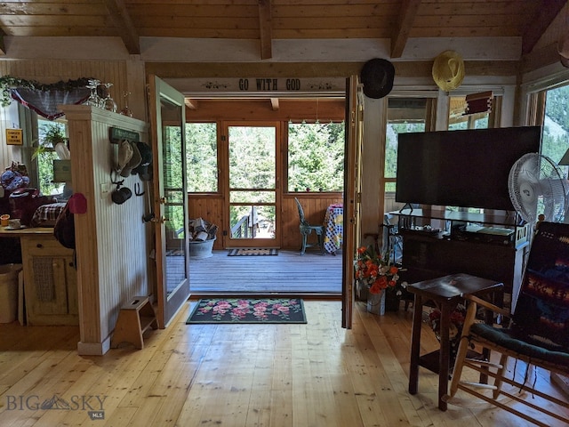 interior space featuring wooden ceiling, light hardwood / wood-style floors, and vaulted ceiling with beams