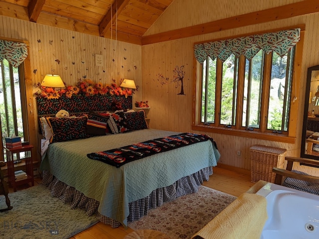 bedroom with hardwood / wood-style flooring, wood ceiling, vaulted ceiling with beams, and wood walls