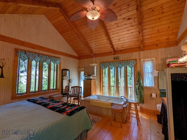 bedroom with beam ceiling, wooden walls, wood ceiling, and hardwood / wood-style floors