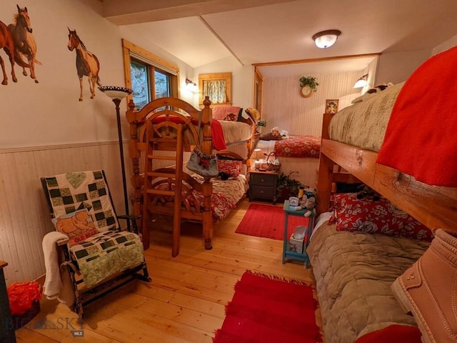 bedroom featuring wood-type flooring and lofted ceiling