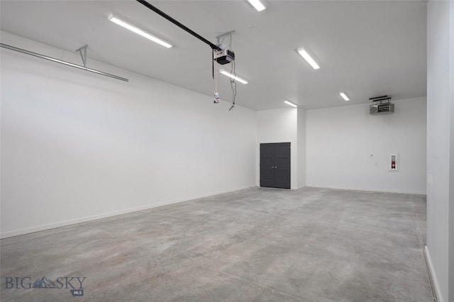 garage featuring a garage door opener and baseboards