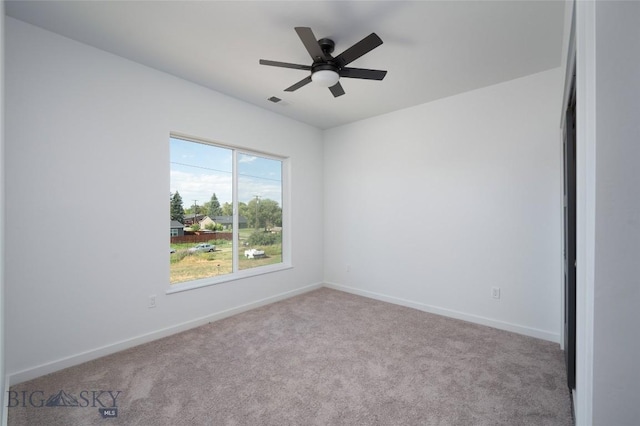 unfurnished room with visible vents, baseboards, ceiling fan, and carpet flooring