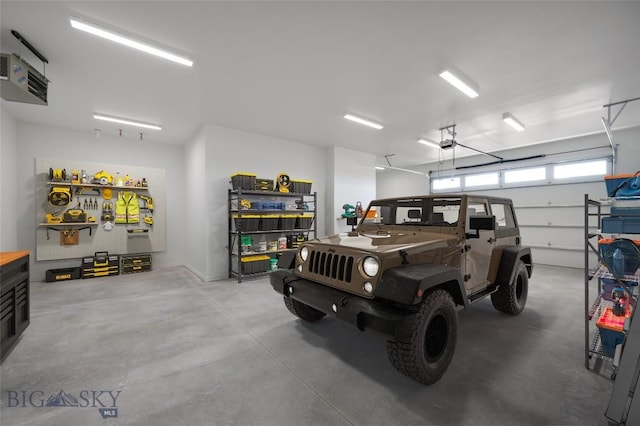 garage with a workshop area and a garage door opener