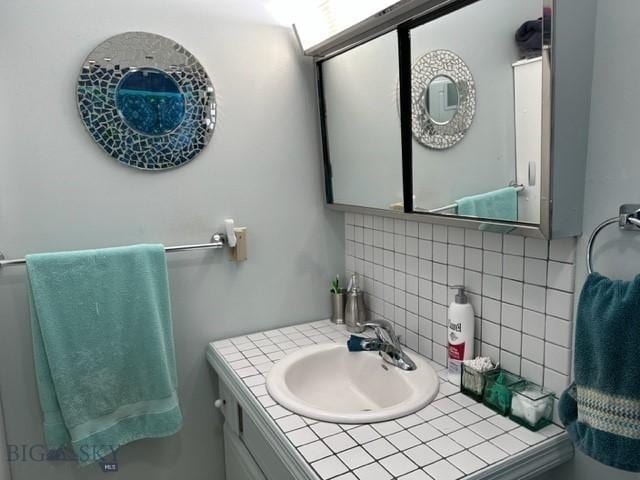 bathroom with a sink and backsplash