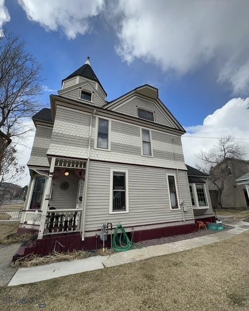 back of property with covered porch