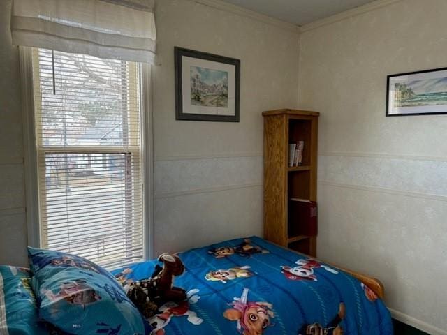 bedroom with multiple windows and crown molding