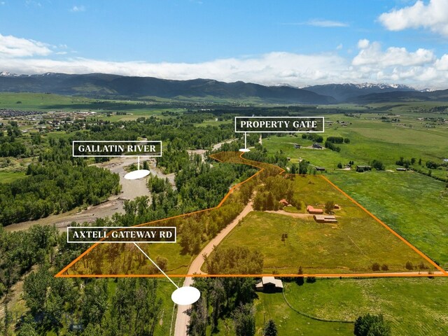 birds eye view of property featuring a mountain view and a rural view