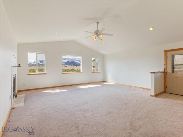 unfurnished living room with lofted ceiling, light carpet, and ceiling fan