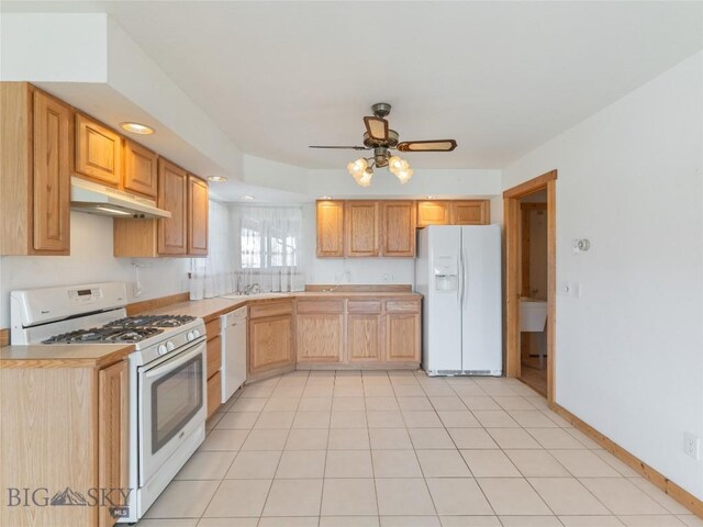 kitchen with sink, white appliances, light tile patterned floors, light brown cabinets, and ceiling fan