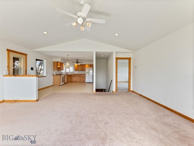 unfurnished living room with ceiling fan, lofted ceiling, and light carpet