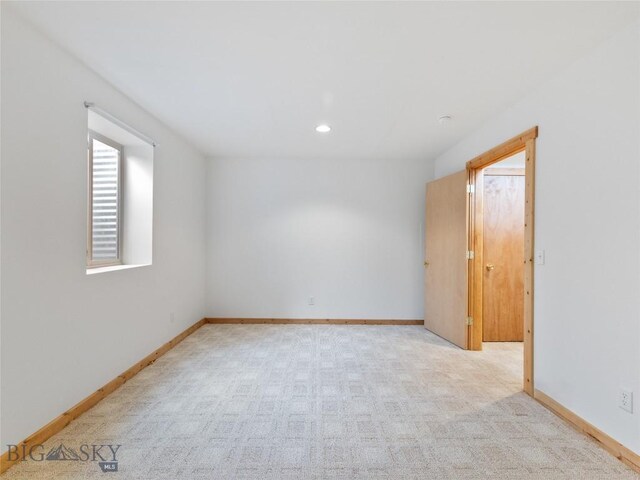 unfurnished room with light carpet