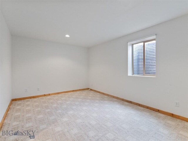 spare room with light colored carpet