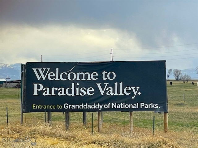 community / neighborhood sign featuring a rural view