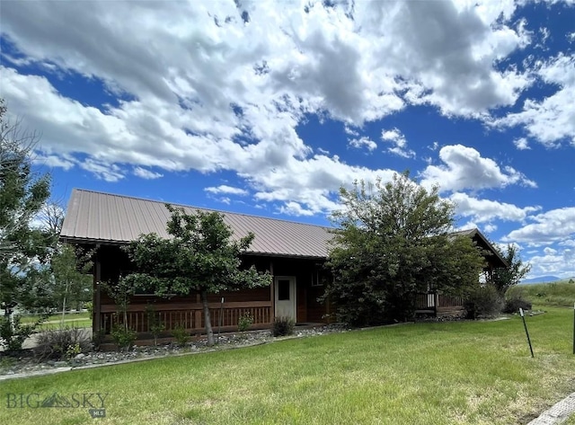 view of property hidden behind natural elements with a front lawn