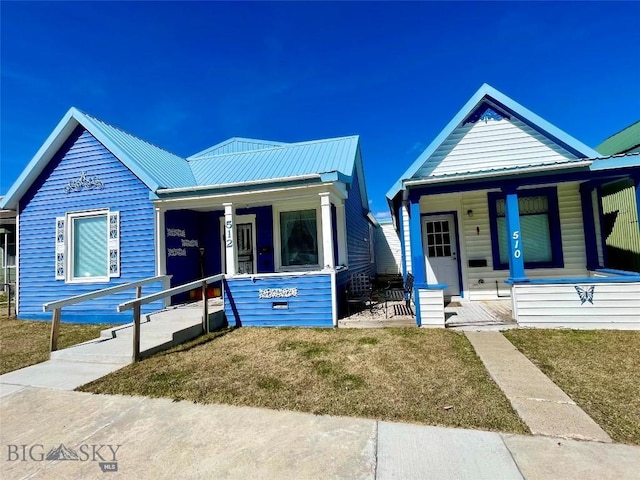 512 W Park, Anaconda, MT 59711 - view of front of property featuring metal roof, a front lawn, and covered porch