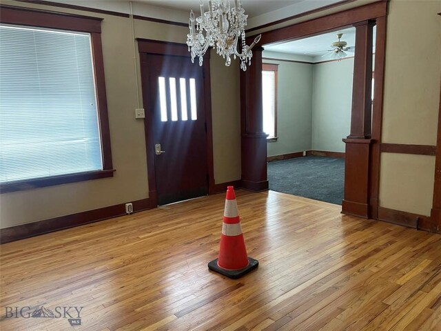 512 W Park, Anaconda, MT 59711 - entryway featuring light wood finished floors, baseboards, crown molding, and ceiling fan with notable chandelier