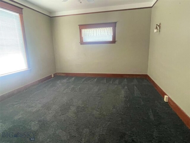 512 W Park, Anaconda, MT 59711 - spare room with baseboards, dark carpet, and ceiling fan
