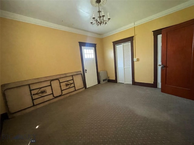 512 W Park, Anaconda, MT 59711 - empty room with carpet, baseboards, ornamental molding, and an inviting chandelier