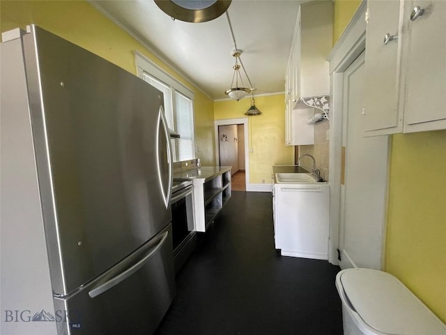 512 W Park, Anaconda, MT 59711 - kitchen with crown molding, hanging light fixtures, a sink, stainless steel appliances, and white cabinets
