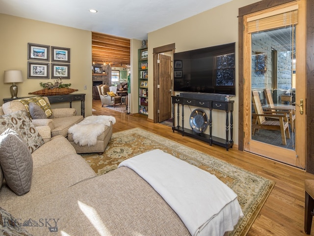 living room featuring hardwood / wood-style flooring and log walls