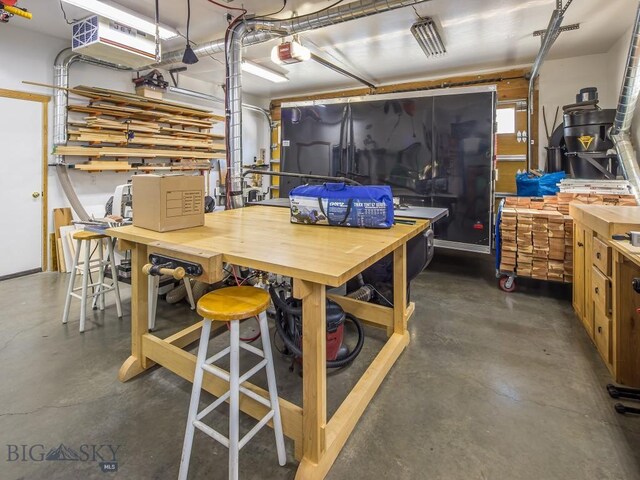 garage with a garage door opener and a workshop area