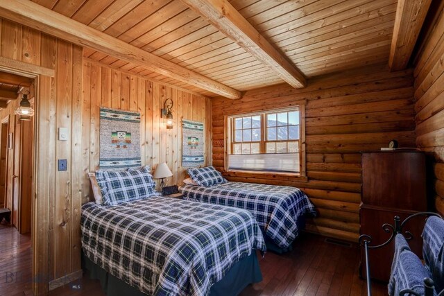54 Torry Rd, Cameron, MT 59720 - bedroom with beamed ceiling, wooden ceiling, hardwood / wood-style floors, and rustic walls