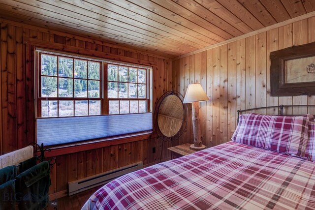 54 Torry Rd, Cameron, MT 59720 - bedroom with a baseboard heating unit, wooden ceiling, and wooden walls