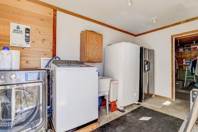 54 Torry Rd, Cameron, MT 59720 - washroom featuring washer and clothes dryer, ornamental molding, wood walls, and cabinet space