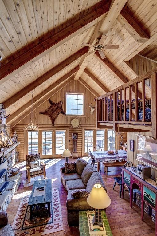 54 Torry Rd, Cameron, MT 59720 - living room featuring wooden ceiling, beam ceiling, high vaulted ceiling, wooden walls, and hardwood / wood-style flooring