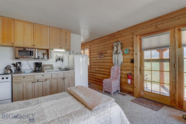 54 Torry Rd, Cameron, MT 59720 - bedroom featuring log walls, carpet, and a sink