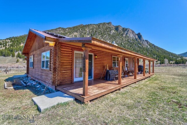 54 Torry Rd, Cameron, MT 59720 - back of house featuring a yard, log siding, a deck with mountain view, and metal roof