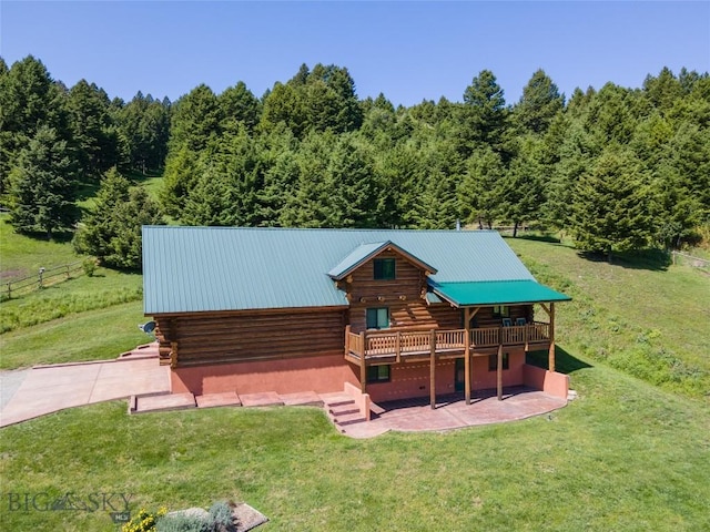 exterior space featuring a wooden deck, a patio area, and a front lawn