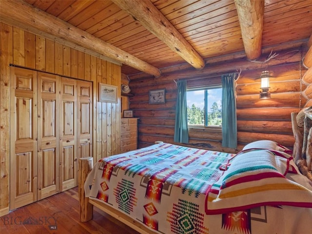 bedroom with log walls, beamed ceiling, wood ceiling, and hardwood / wood-style flooring