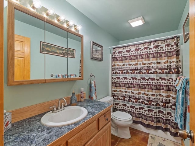 bathroom featuring tile patterned flooring, a shower with curtain, vanity, and toilet