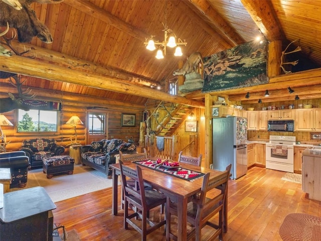 dining space with beamed ceiling, light hardwood / wood-style flooring, log walls, and an inviting chandelier