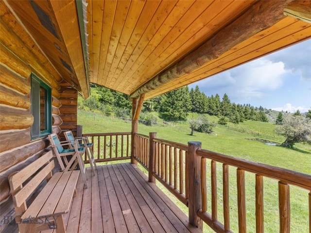 wooden deck featuring a yard