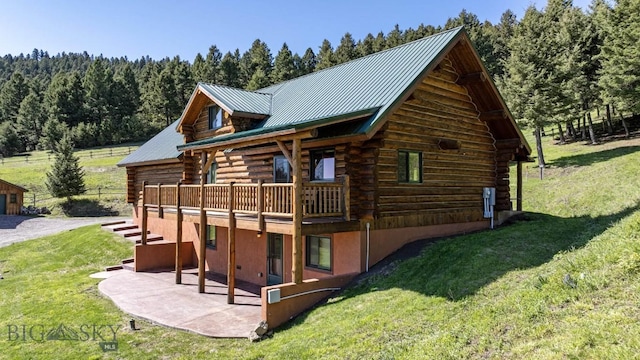 72 Sky Band Trl, Livingston, MT 59047 - back of house with log exterior, a patio, a lawn, and metal roof