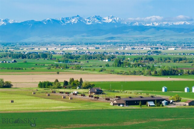 surrounding community with a mountain view, a yard, and a rural view